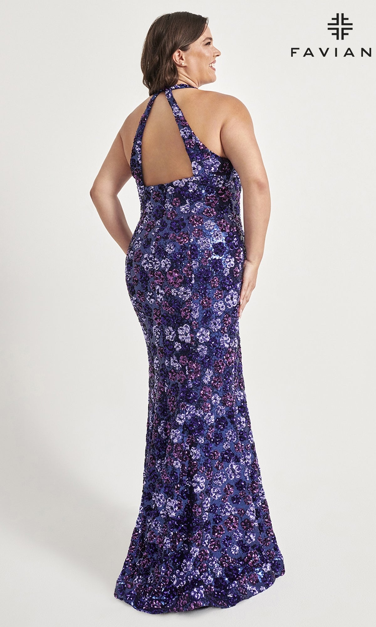 A woman in a floor-length, sleeveless, purple Floral-Sequin Plus-Size Prom Dress 9560 with a halter neck and open back stands smiling. The Faviana logo is in the top right. Ideal for prom or special occasions.